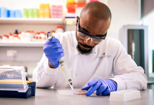 Image of scientist using a dropper